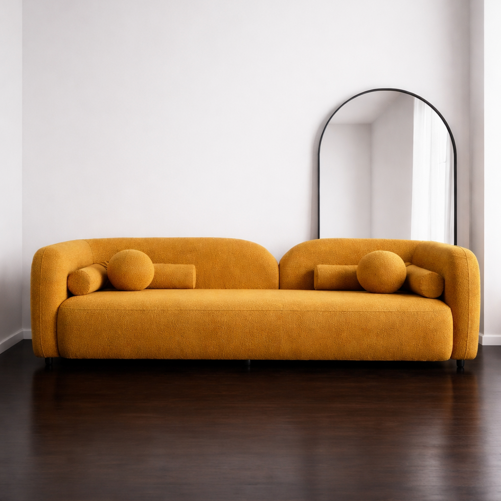 Mustard yellow sofa in a minimalistic room with a mirror on the wall. 