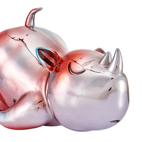 Metallic pink and silver bull sculpture on a white background