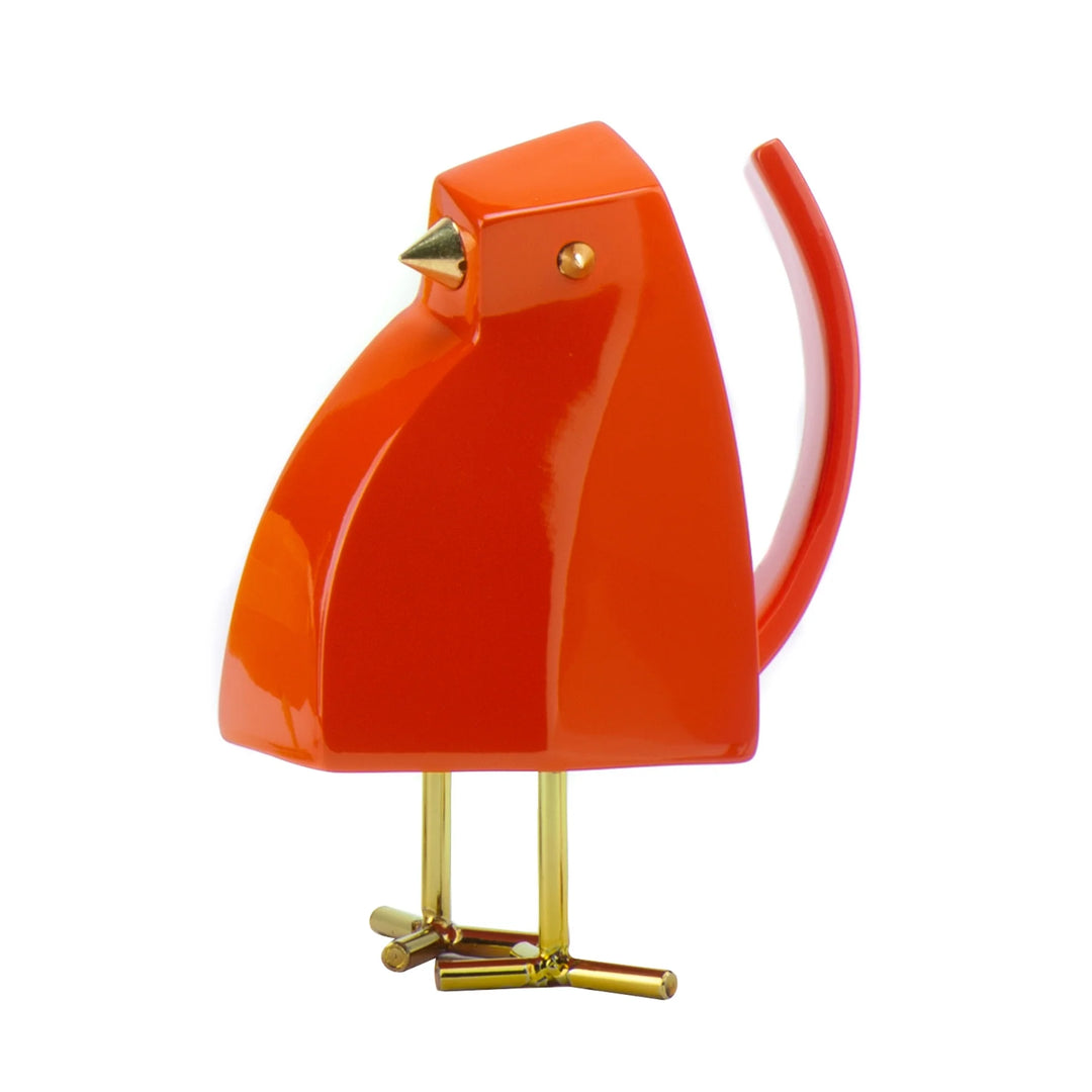 Orange bird-shaped object with gold accents on a white background