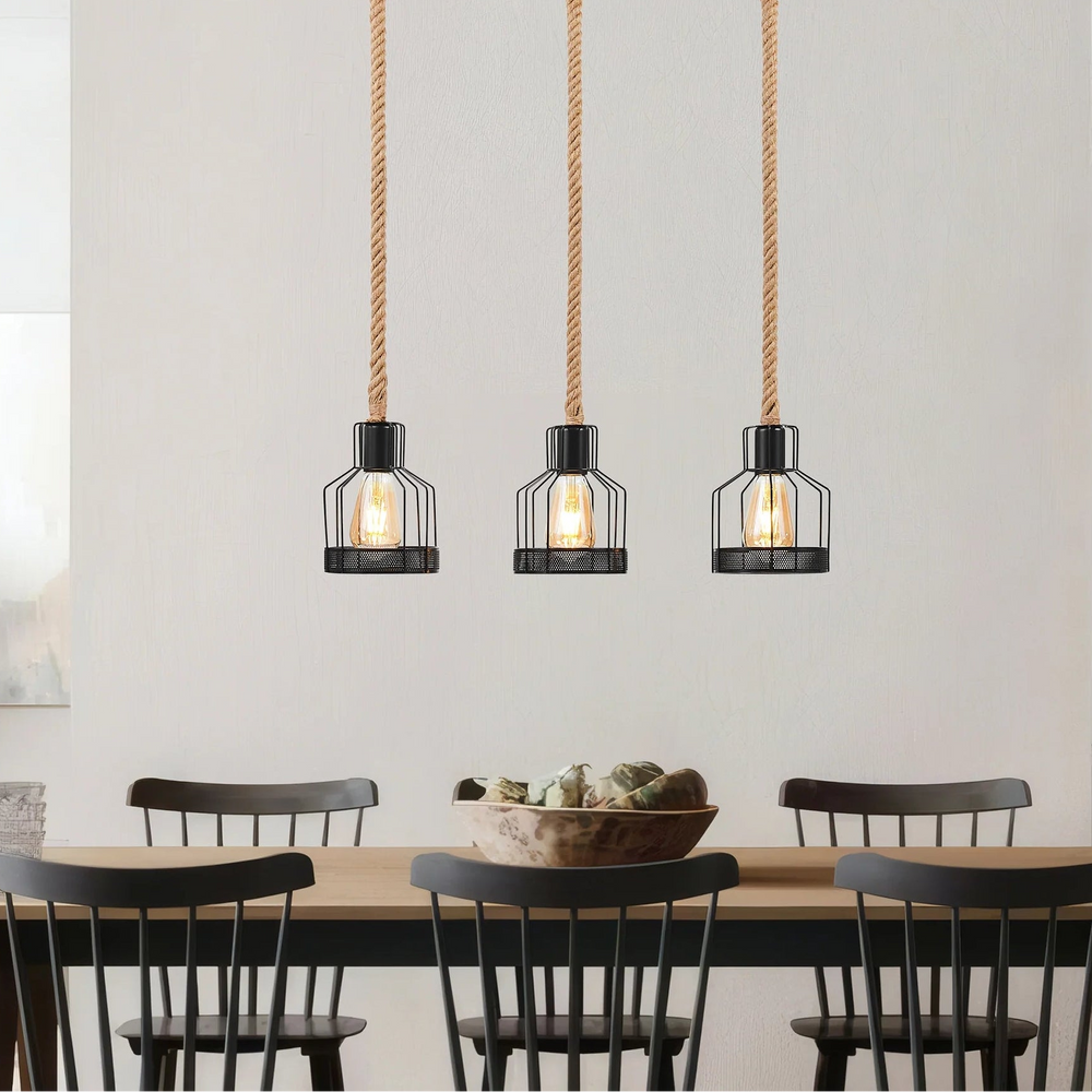 Modern pendant light with three glass shades hanging above a dining table.