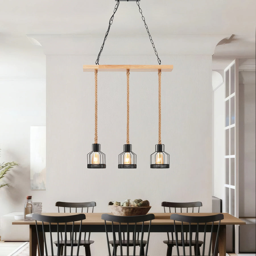 Modern pendant light with three glass shades hanging above a dining table.