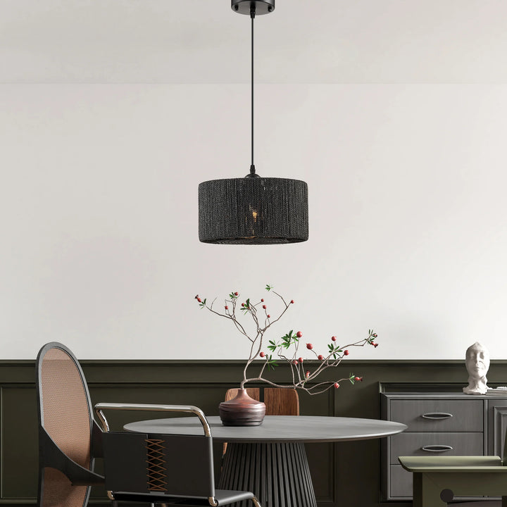 Modern interior with a black pendant light, round table, and decorative elements.
