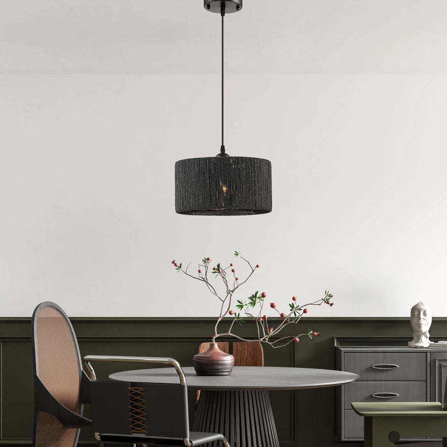 Modern interior with a black pendant light, round table, and decorative elements.