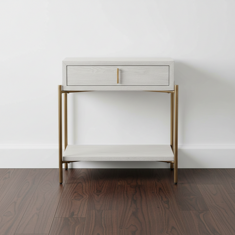 White side table with gold legs against a white wall
