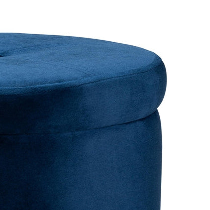 Blue ottoman with gold legs on a white background