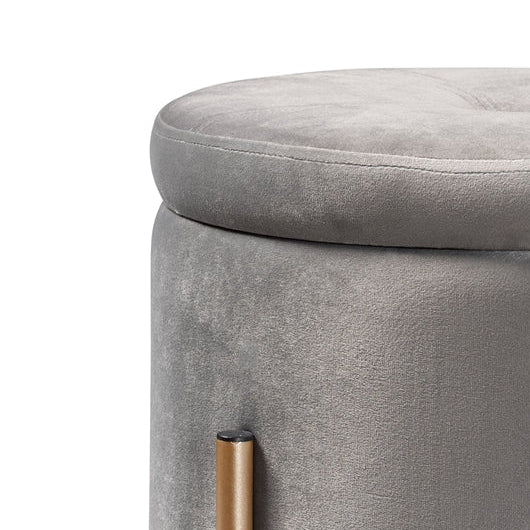 Gray upholstered ottoman with gold legs on a white background