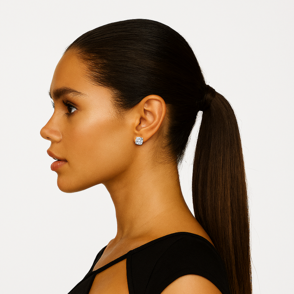 This 1 cttw Stud earrings crafted in 14k white gold display hand-picked near-colorless round cut diamonds in four-prong settings and secured with push backs.