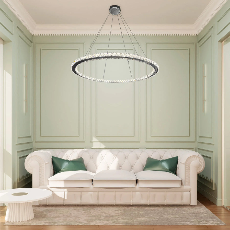 Modern living room with a white sofa, green cushions, and a circular chandelier.