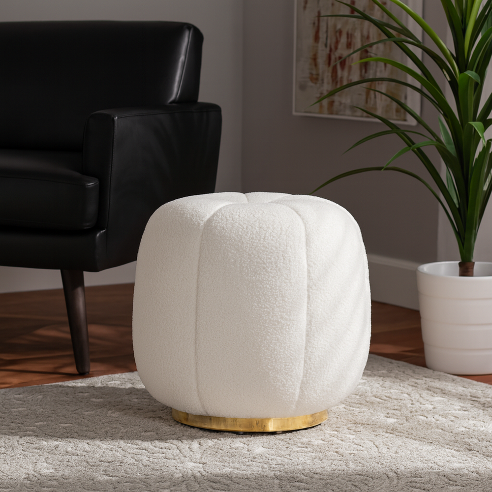 White textured ottoman with gold base in a living room setting