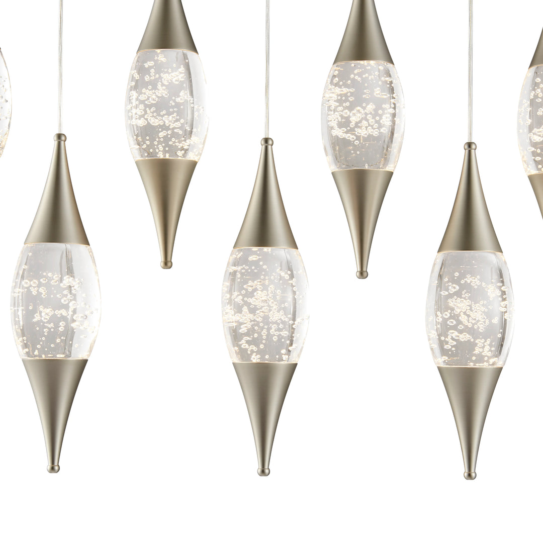 Decorative hanging lights with metallic bases and clear glass shades on a white background