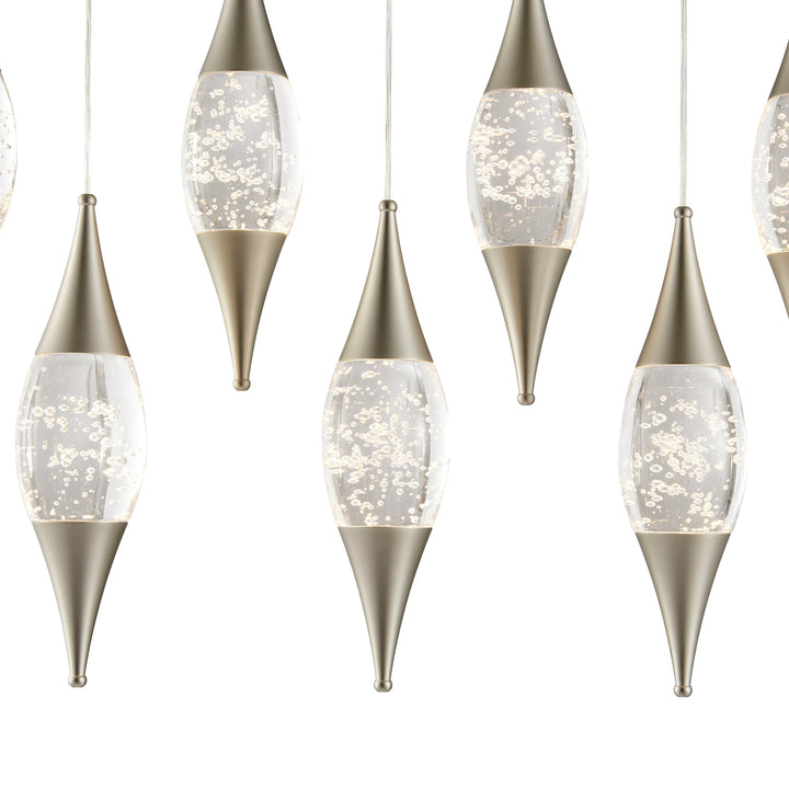 Decorative hanging lights with metallic bases and clear glass shades on a white background