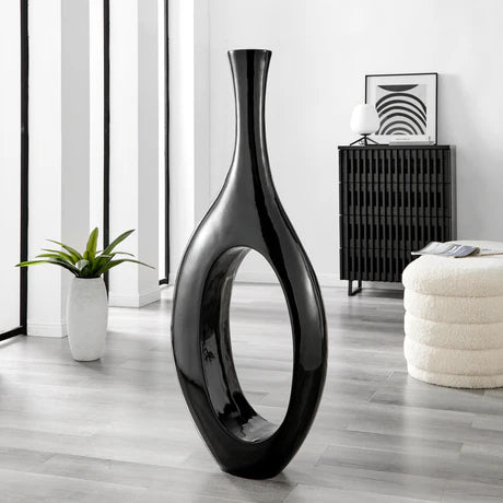 Trombone Vase – Large Black

A statement piece for high-style interiors, the Trombone Vase – Large Black features a sleek oval silhouette and a glossy black finish, making it a bold yet sophisticated decor element. Crafted from premium resin with smooth, sculptural curves, it’s perfect for entryways, foyers, and modern living spaces.

Designed for luxury interiors, this vase stands alone as a striking sculpture or pairs beautifully with statement florals*.