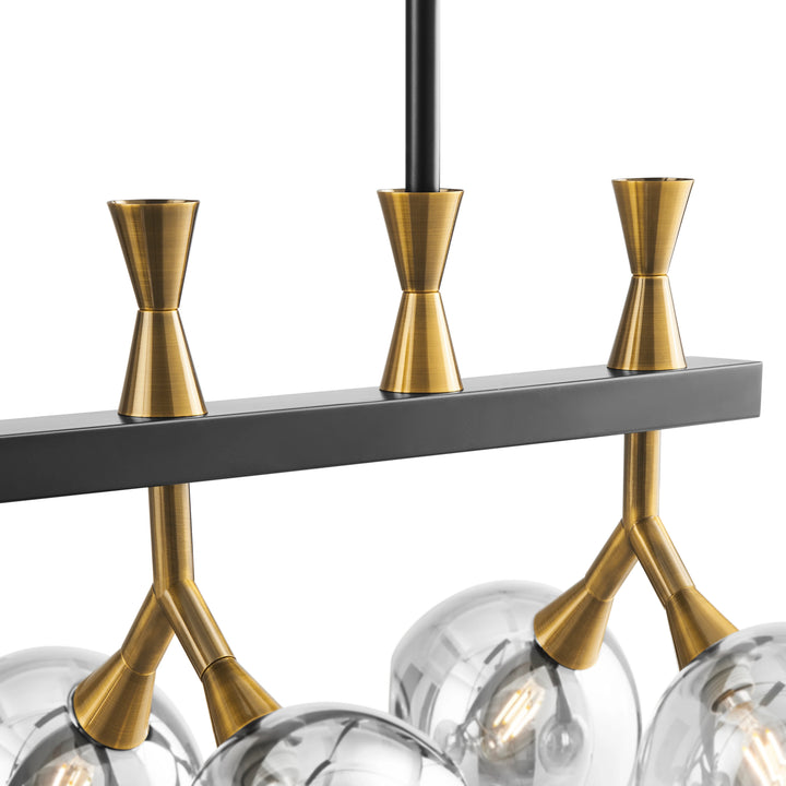 Modern chandelier with gold arms and clear glass shades on a white background 