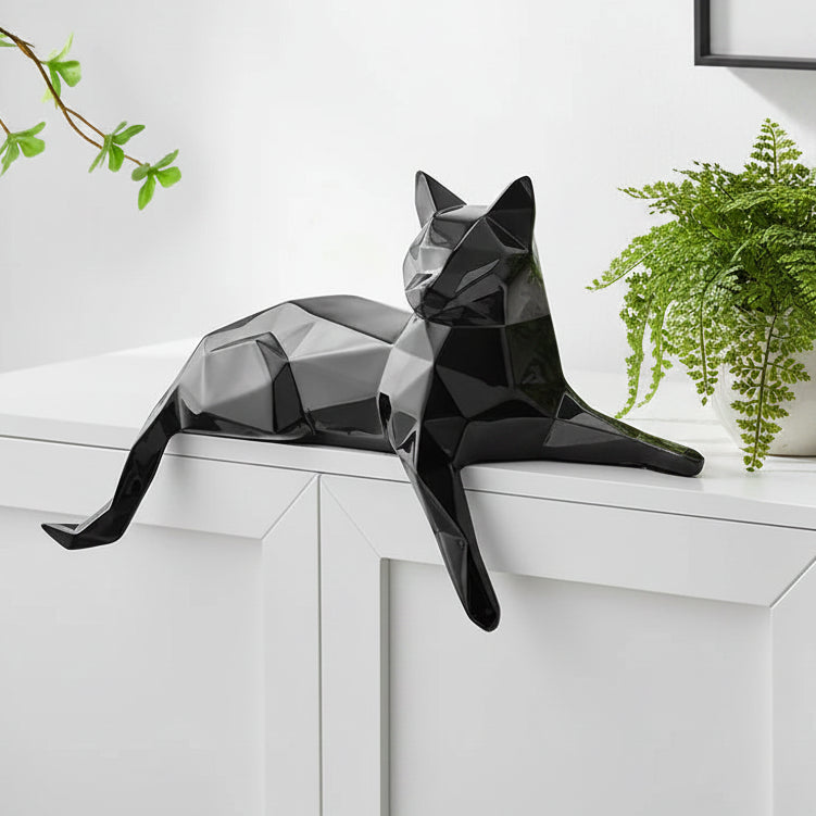 Black geometric cat sculpture on a white surface with a minimalistic background