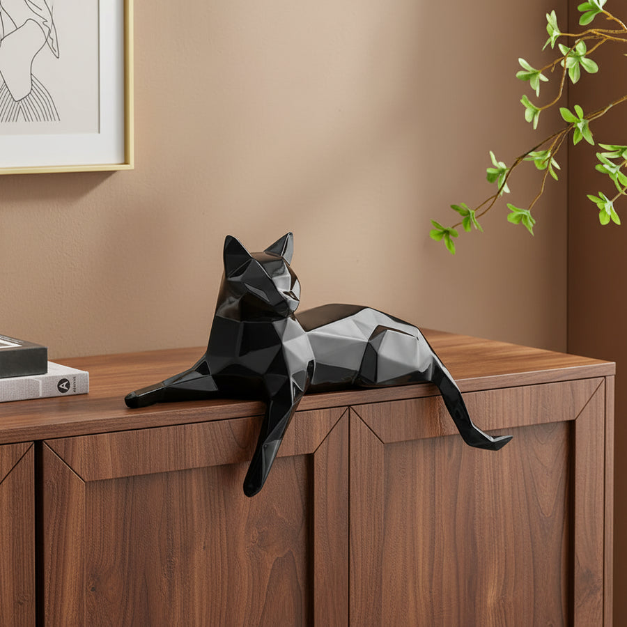 Black geometric cat sculpture on a white surface with a minimalistic background 