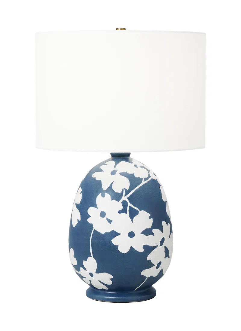 Lila Table Lamp Inspired by the enchanting dogwood trails in East Texas, the Lila Table Lamp features a charming, hand-painted floral design. The ceramic body is adorned with a leather-like finish, adding a touch of texture and sophistication. Paired with a crisp white linen shade, the Lila brings both cheerful elegance and functional illumination to any space. Designed with convenience in mind, the lamp includes an easy-to-use on/off switch located on the socket.