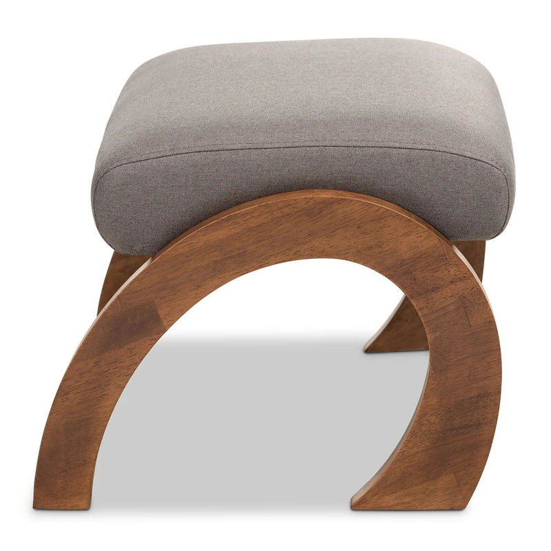 Stool with gray cushioned top and wooden base on a white background