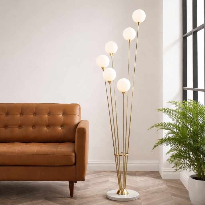 Modern living room with a brown sofa, floor lamp, and potted plant.