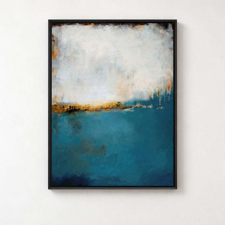 A framed abstract landscape painting featuring a deep teal blue lower section and a textured off-white and gold upper section, displayed on a clean white wall above a light gray floor. 
