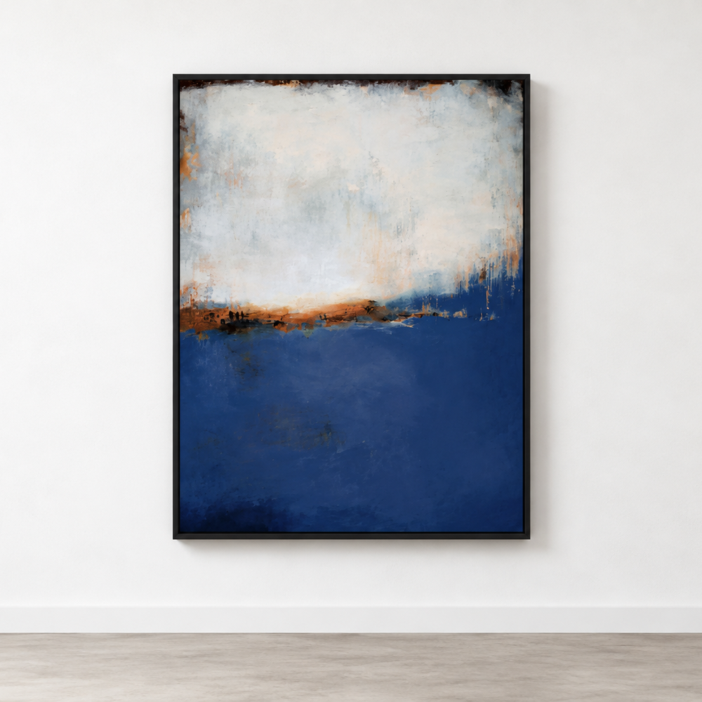 An abstract framed painting hanging on a white wall above a light wood floor. The artwork features a deep navy blue lower section, a white upper section, and a thin band of warm brown/orange tones in the middle, enclosed in a thin black frame.