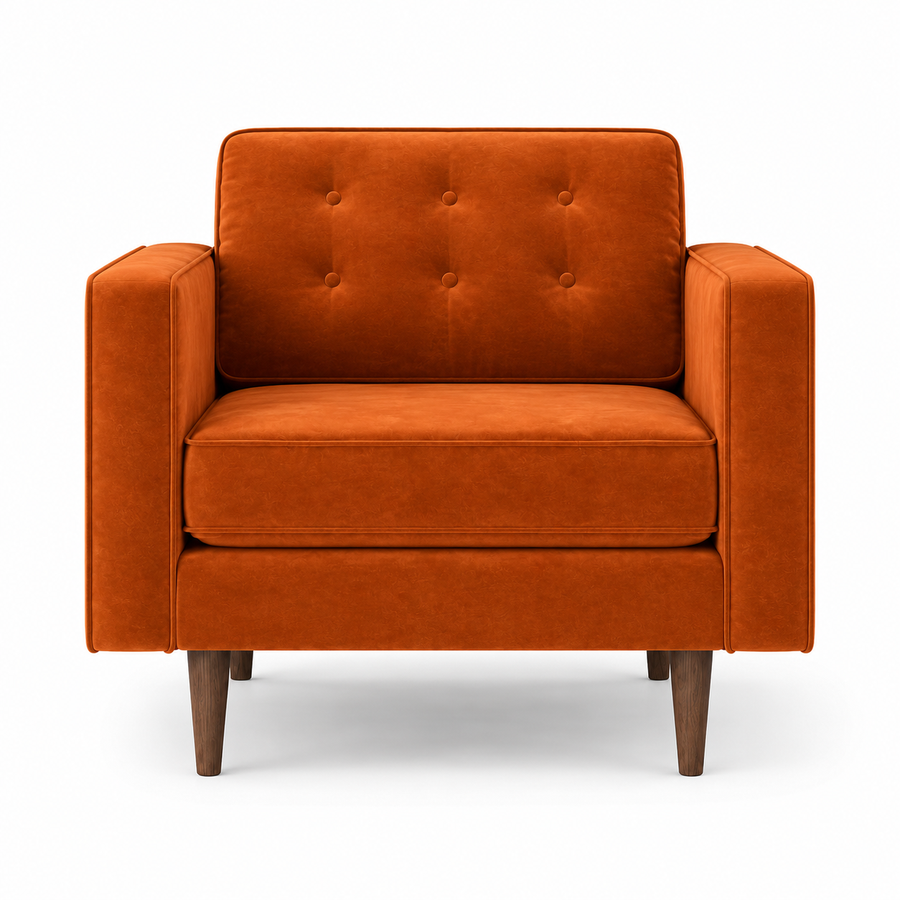 An orange velvet armchair with a tufted backrest and tapered wooden legs, shown against a plain white background.