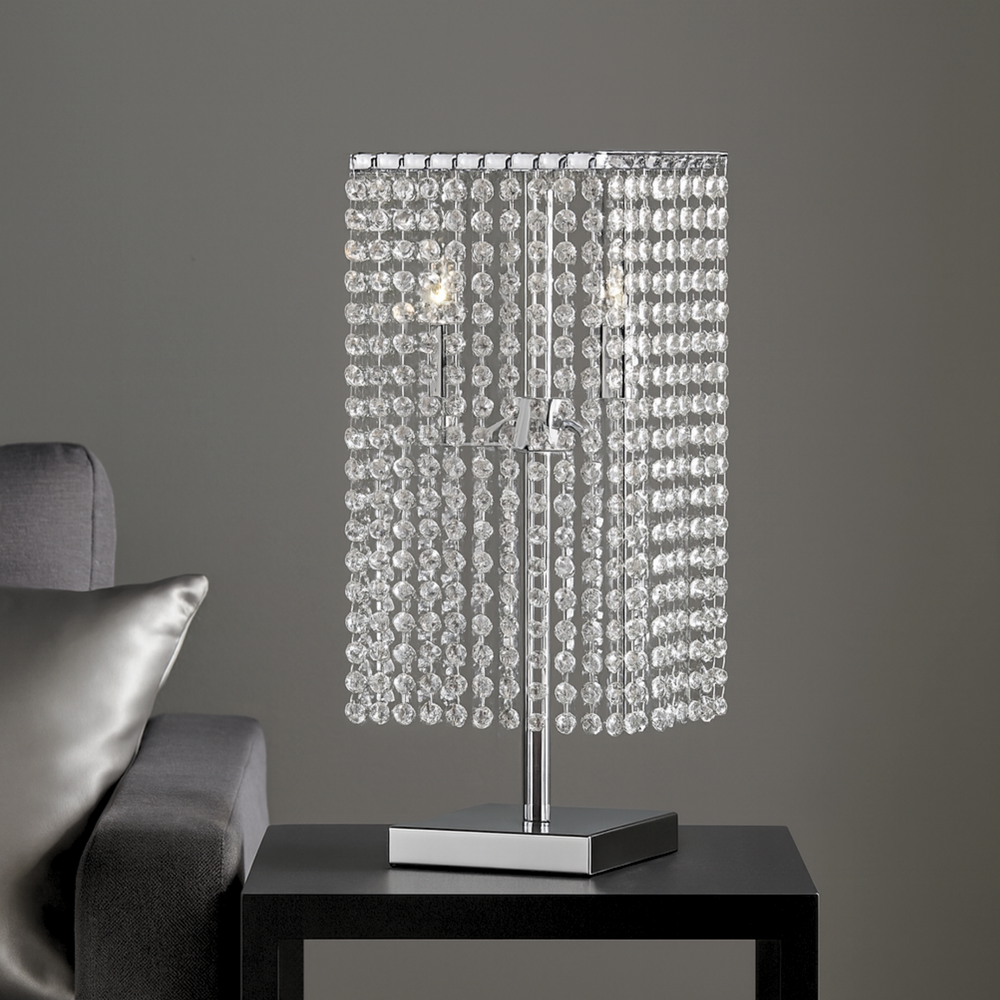 &nbsp;Crystal Table Lamp

This Crystal Table Lamp; This stunning piece, adorned with cascading crystal strands, is designed to fill any room with warmth and sophistication. Its chrome finish and sleek profile blend seamlessly into contemporary decor, making it both a stylish and practical lighting solution.