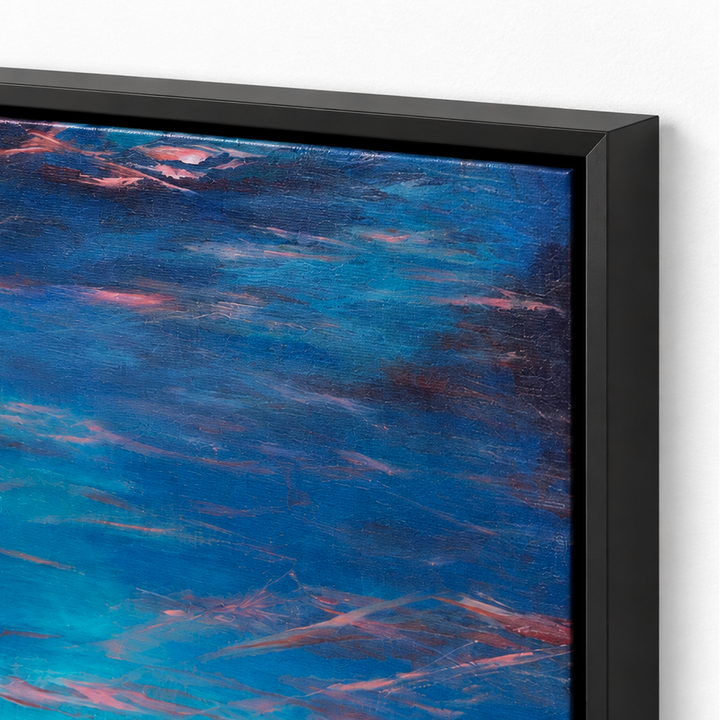 Close-up of a framed abstract painting with swirling blue, turquoise, and pink brushstrokes inside a black frame against a white wall.