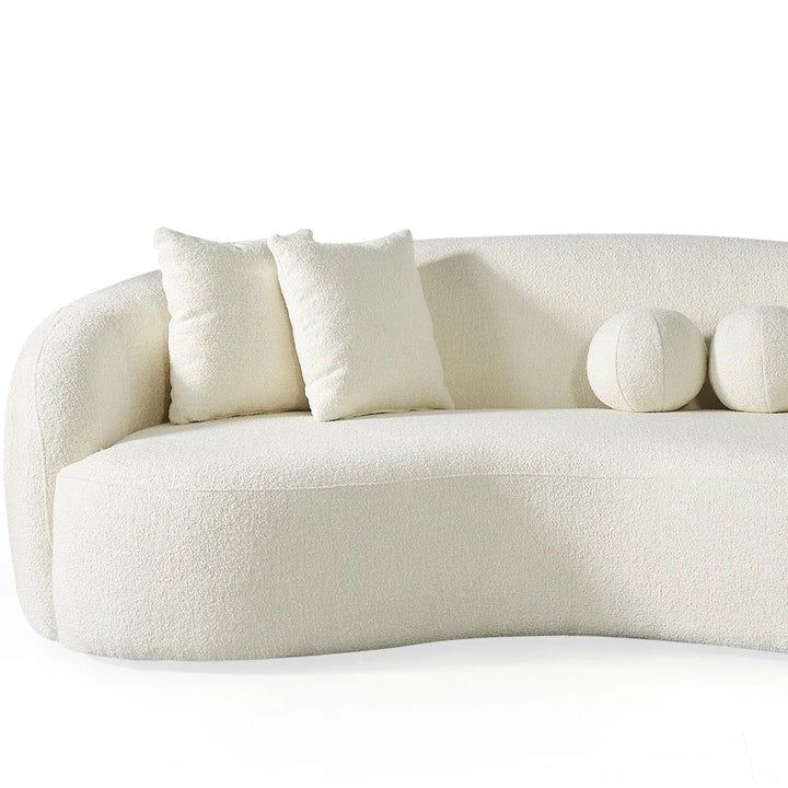 White sofa with decorative spherical elements on a white background