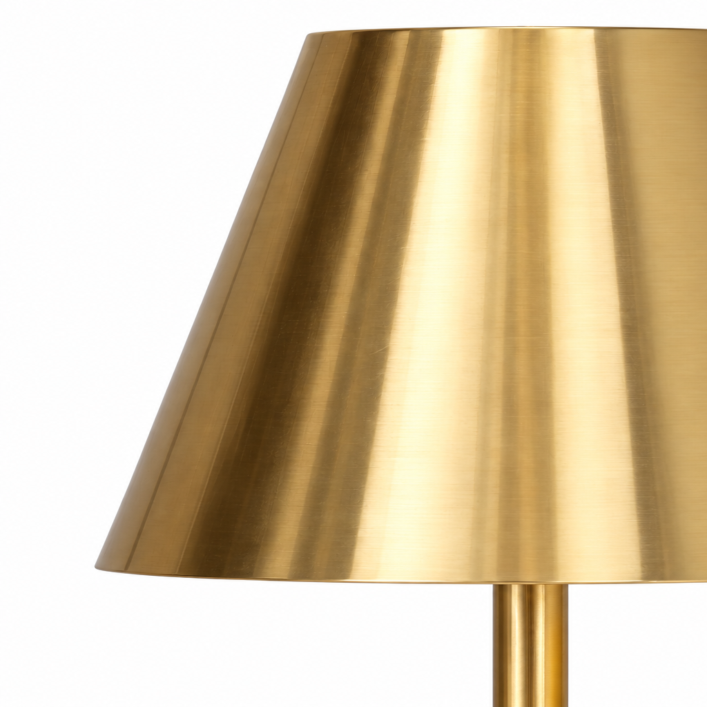 A brushed brass table lamp shade with a matching brass stem, shown against a solid white background.   