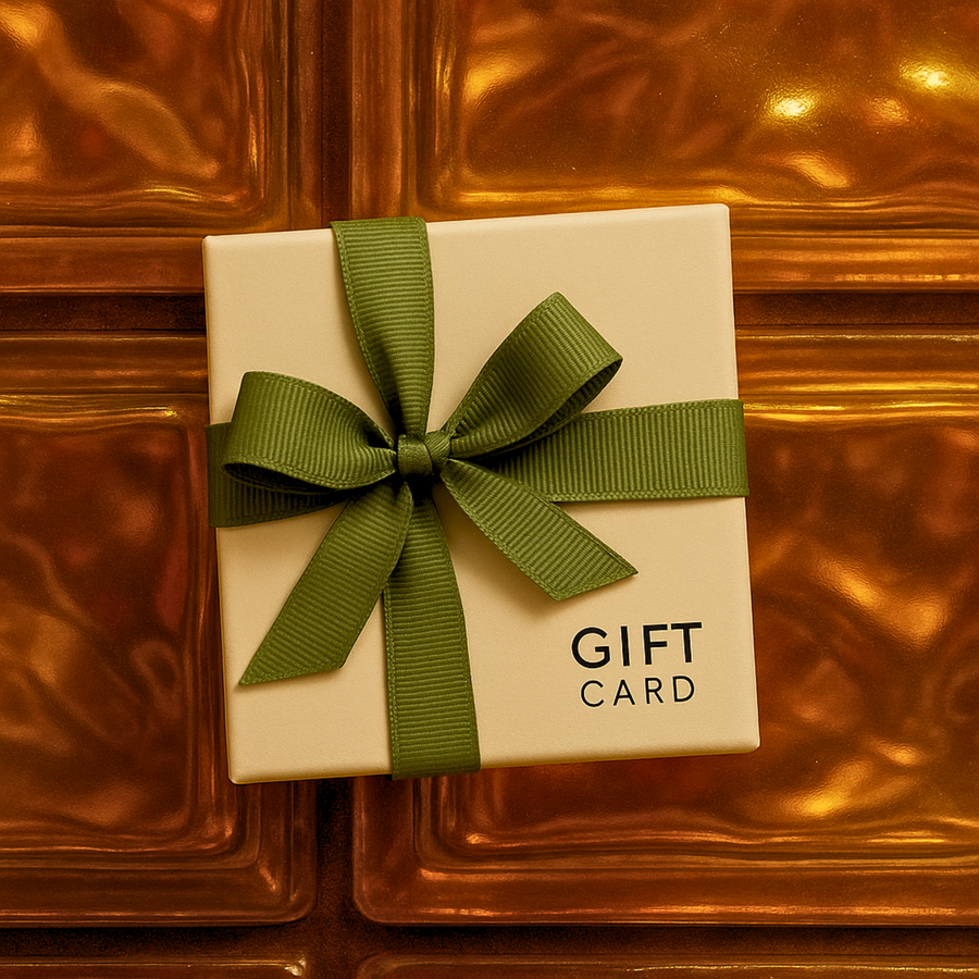 Gift card in a box with a green ribbon on a reflective gold surface