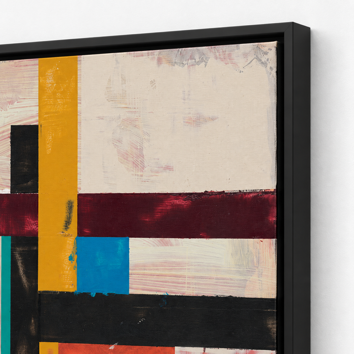 A framed abstract geometric wall art print with bold horizontal and vertical color blocks in cream, mustard yellow, burgundy, black, blue, and teal, shown in a black float frame against a white wall.