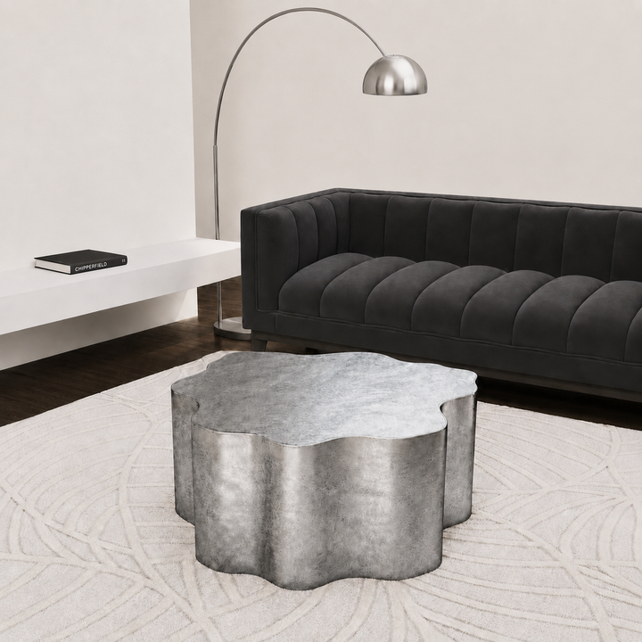 Modern living room with a black sofa, concrete coffee table, and a floor lamp. 