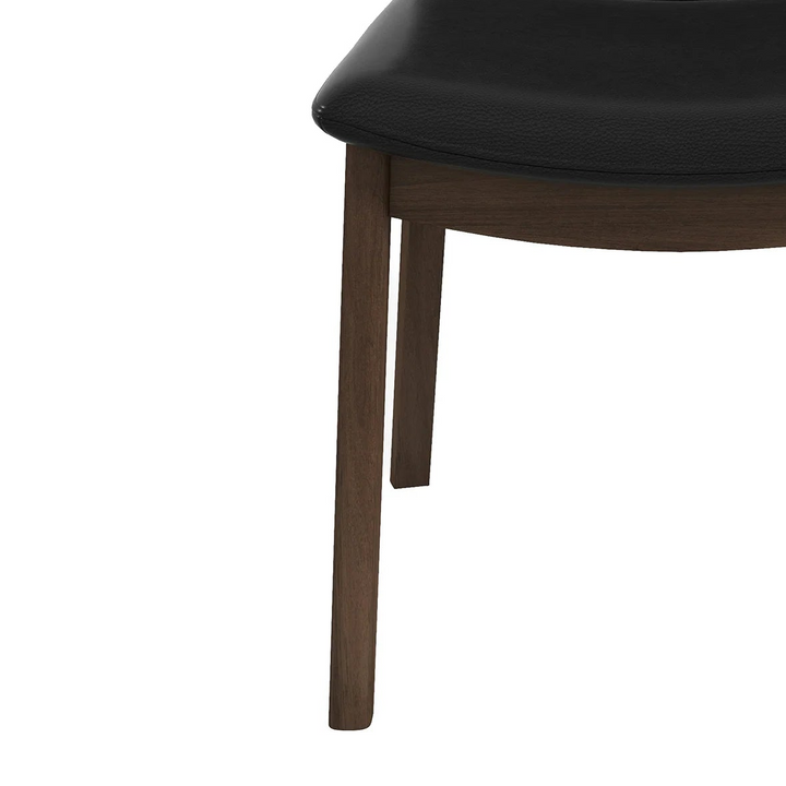 Black chair with wooden legs on a white background 
