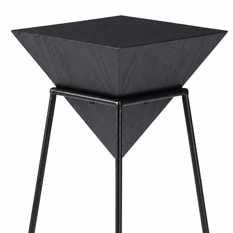 A modern black metal and wood side table featuring a square top, a pyramid-shaped wooden tray mounted on a square metal frame base, shown against a plain white background.