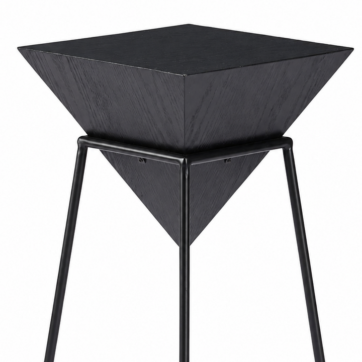 A modern black metal and wood side table featuring a square top, a pyramid-shaped wooden tray mounted on a square metal frame base, shown against a plain white background.