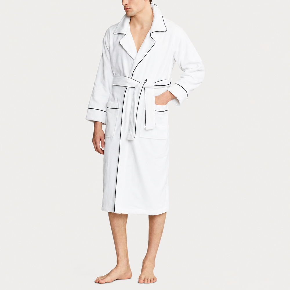 Man wearing a white robe on a plain background
