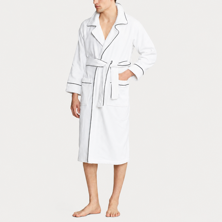 Man wearing a white robe on a plain background
