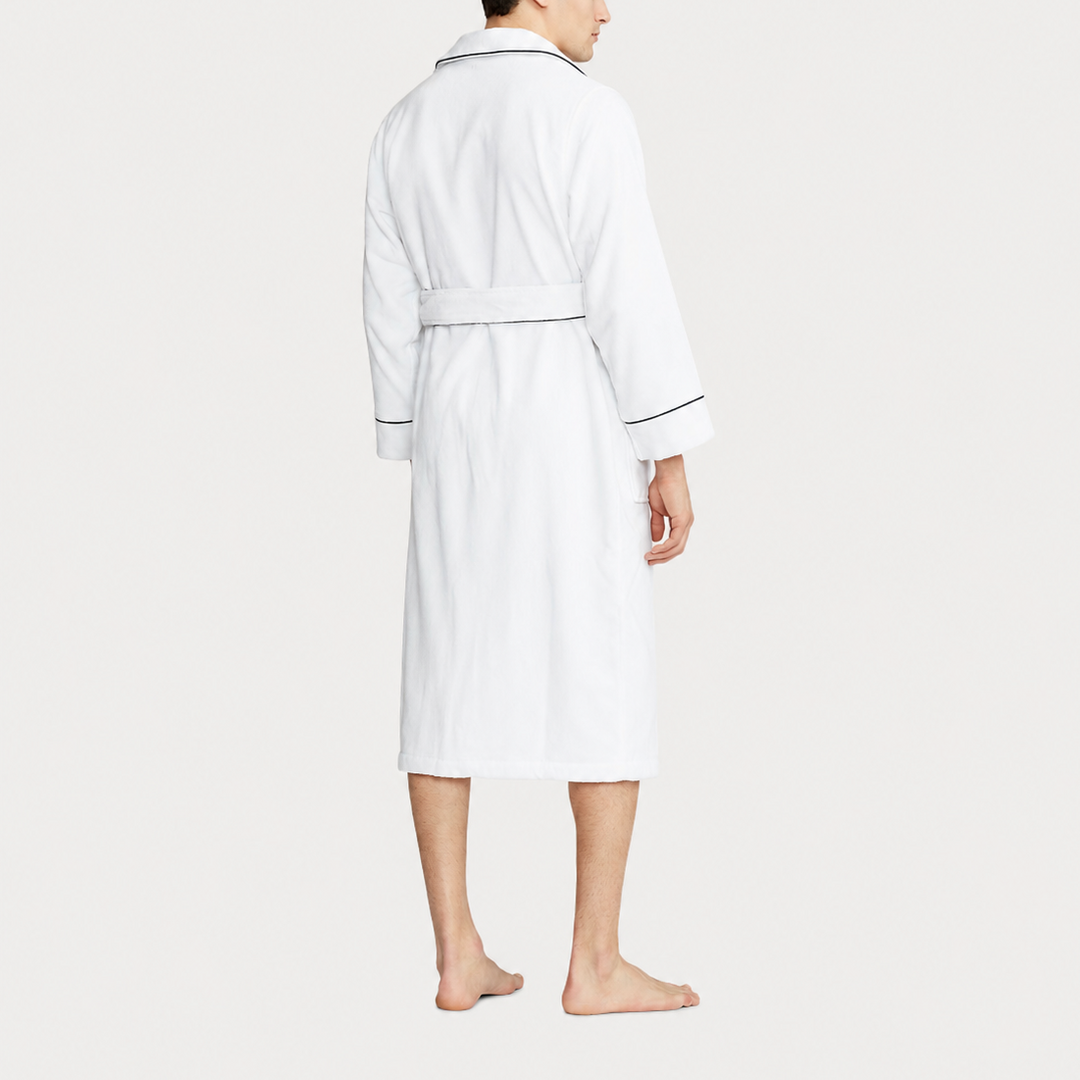Person wearing a white robe on a plain background