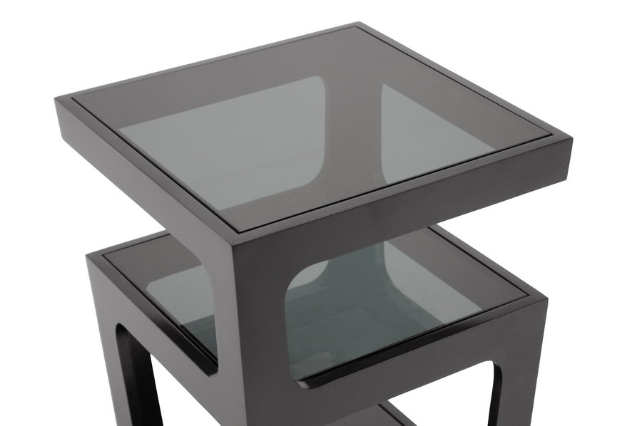 Two black glass tables stacked on a white background