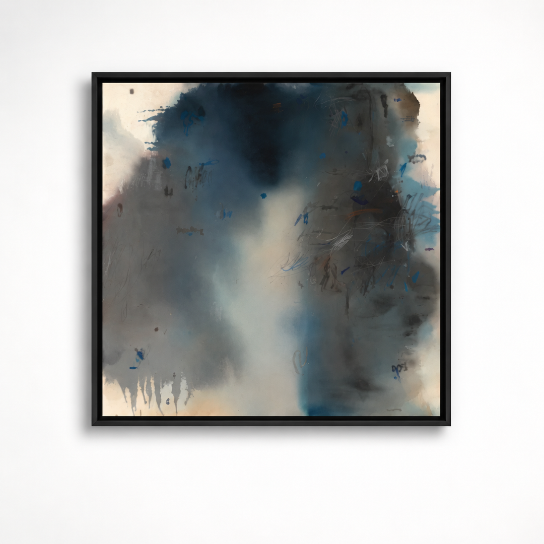 A framed abstract canvas print featuring textured brushstrokes of dark blue, charcoal gray, black, and soft beige, presented in a black frame against a clean white wall.