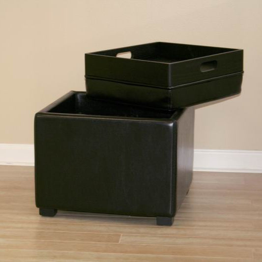 Black storage ottoman with two matching black trays on a wooden floor.