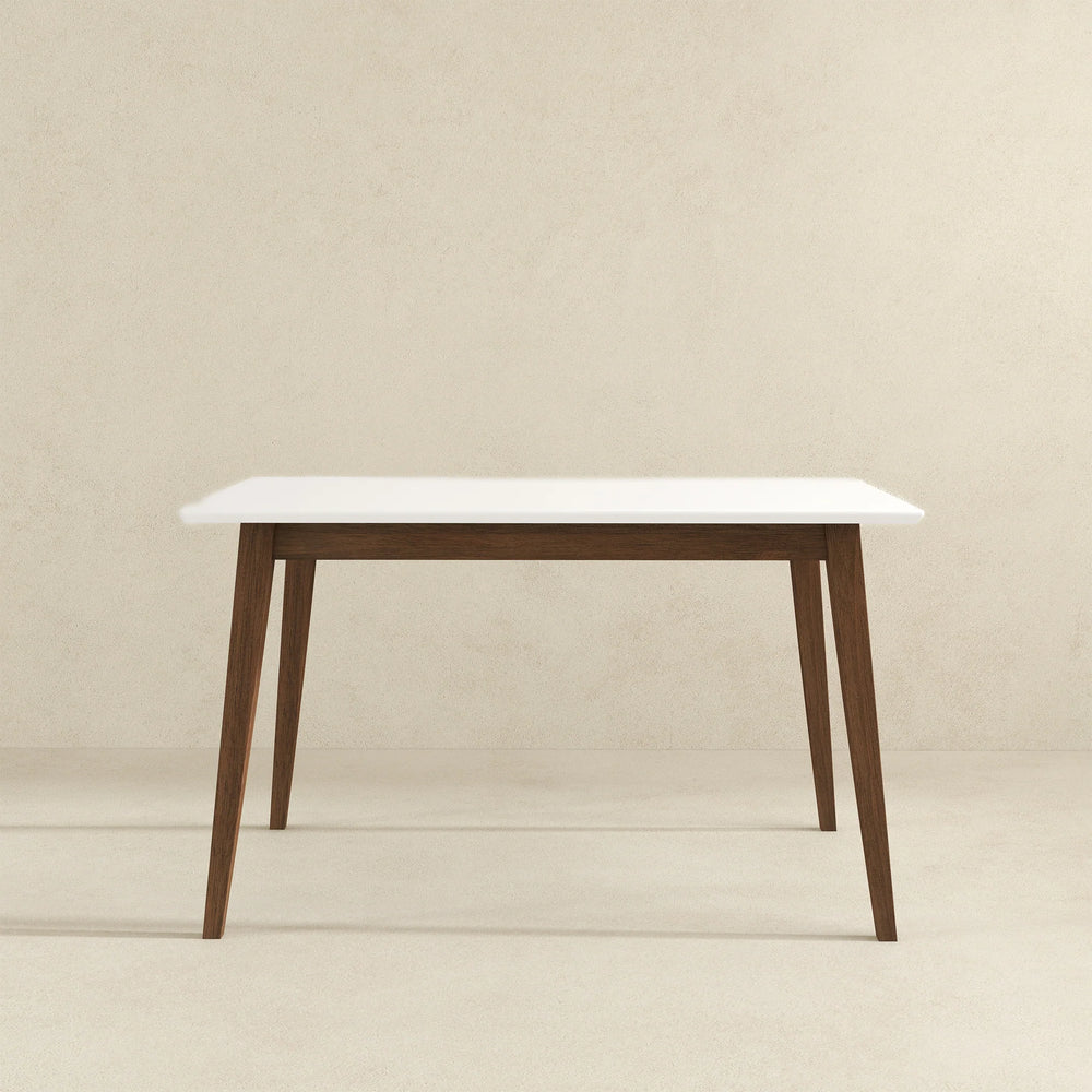 White table with wooden legs on a beige background