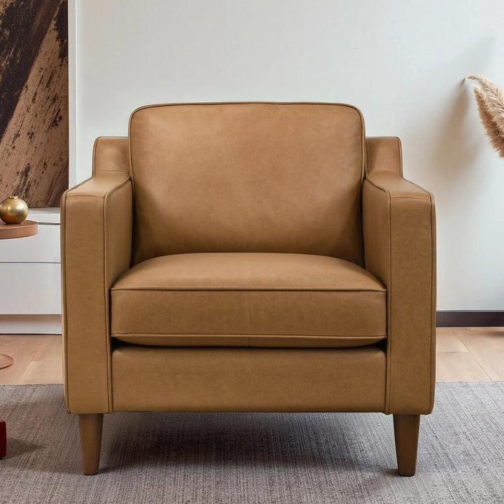 Brown armchair in a modern living room with a rug and small table.