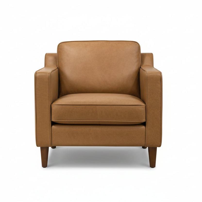 Brown armchair in a modern living room with a rug and small table.