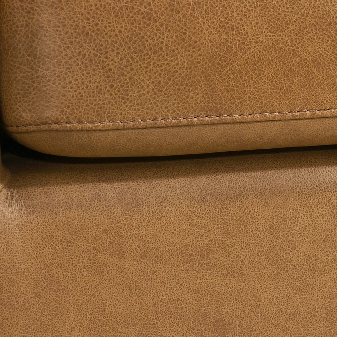 Close-up of a brown leather sofa corner 