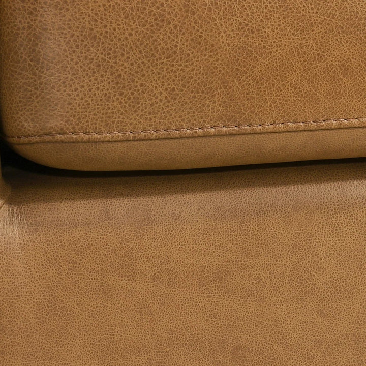 Close-up of a brown leather sofa corner 