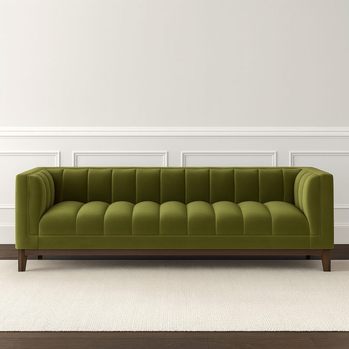 Green sofa in a room with white walls and wooden flooring