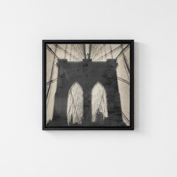 A square framed art print depicting a black and white sketch of the Brooklyn Bridge, mounted on a plain white wall.