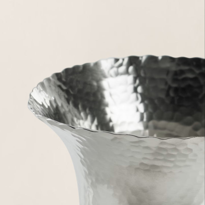 An artful hand-hammered technique creates the distinctive pebbled texture that defines our Evans pitcher. Made with brass, it features a lustrous nickel finish that highlights natural variations throughout.