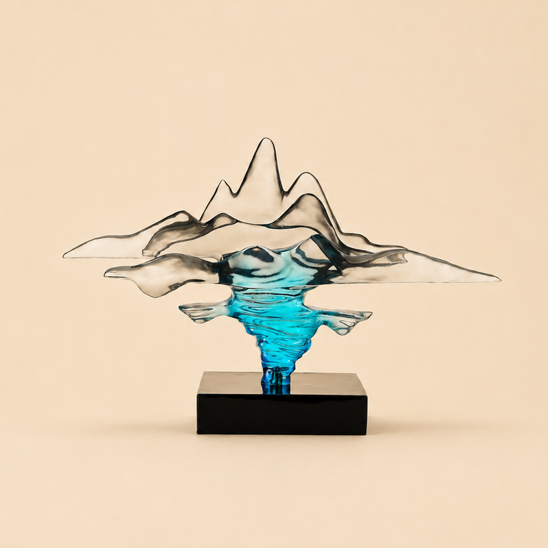 Abstract glass sculpture with blue center on a beige background 
